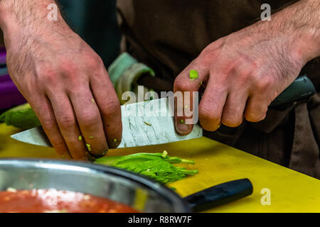 Male Chef Slicing Avocado for  Wedding Meal - Kitchen Set with Isolated Action, Only Chef`s Hands Stock Photo
